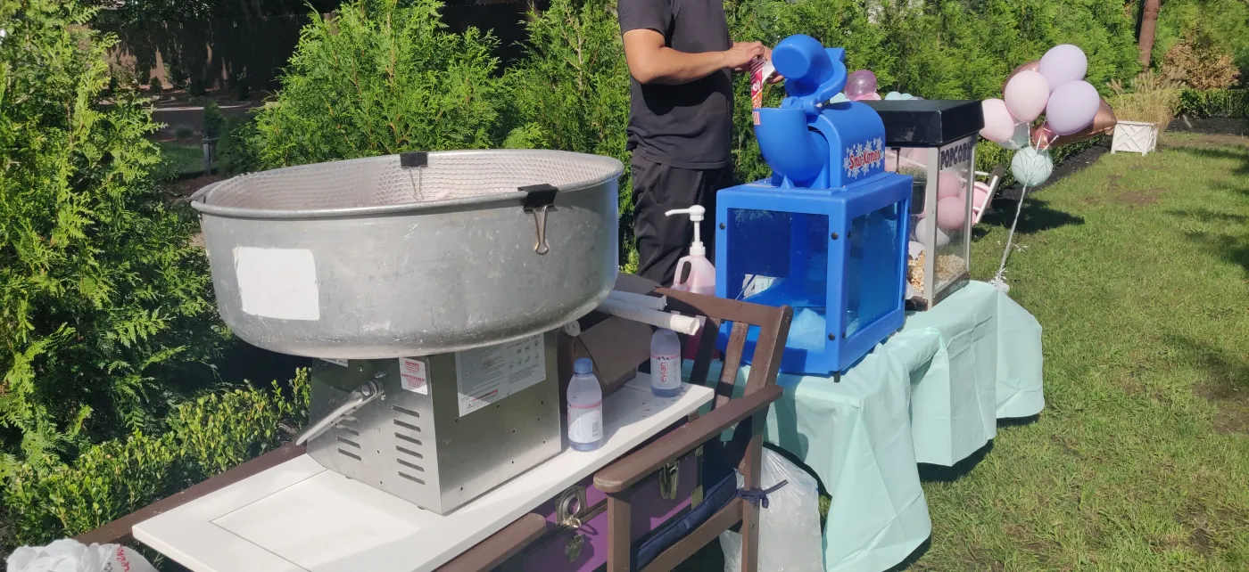 An outdoor table with treat machines and supplies